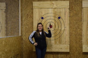 Heather hits a bullseye at Stick It axe throwing